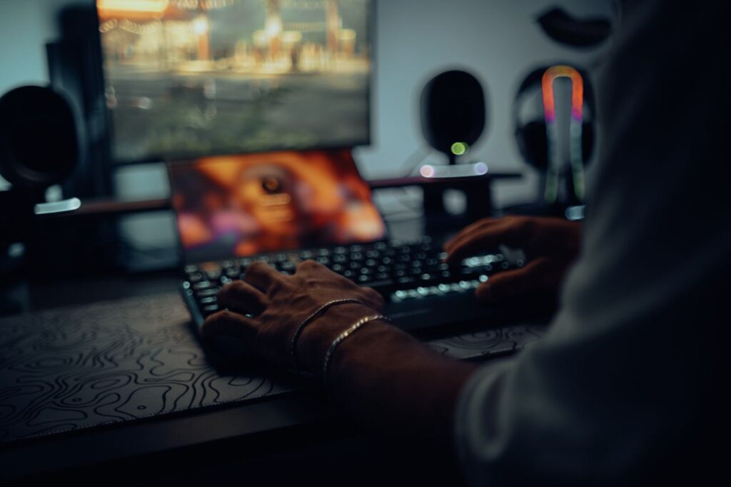 The Entrepreneur’s Guide to Turning Ideas Into Profitable Focused man typing in a dimly lit room, creating a moody atmosphere.