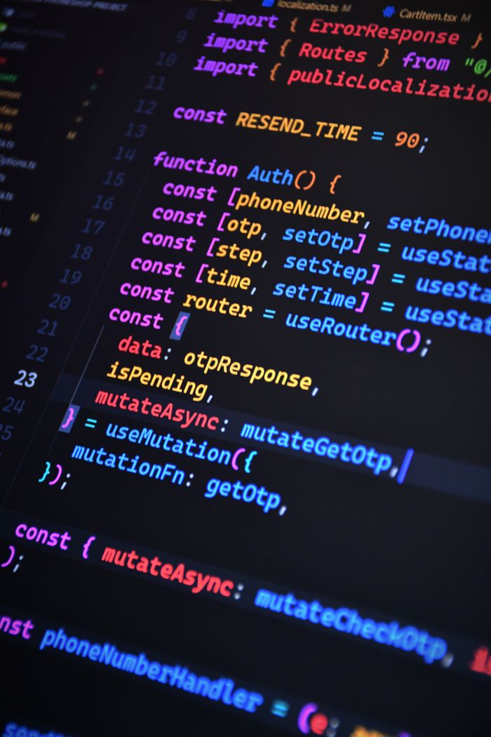 services-03 Close-up of vibrant JavaScript code for web development with ReactJS and Tailwind CSS.